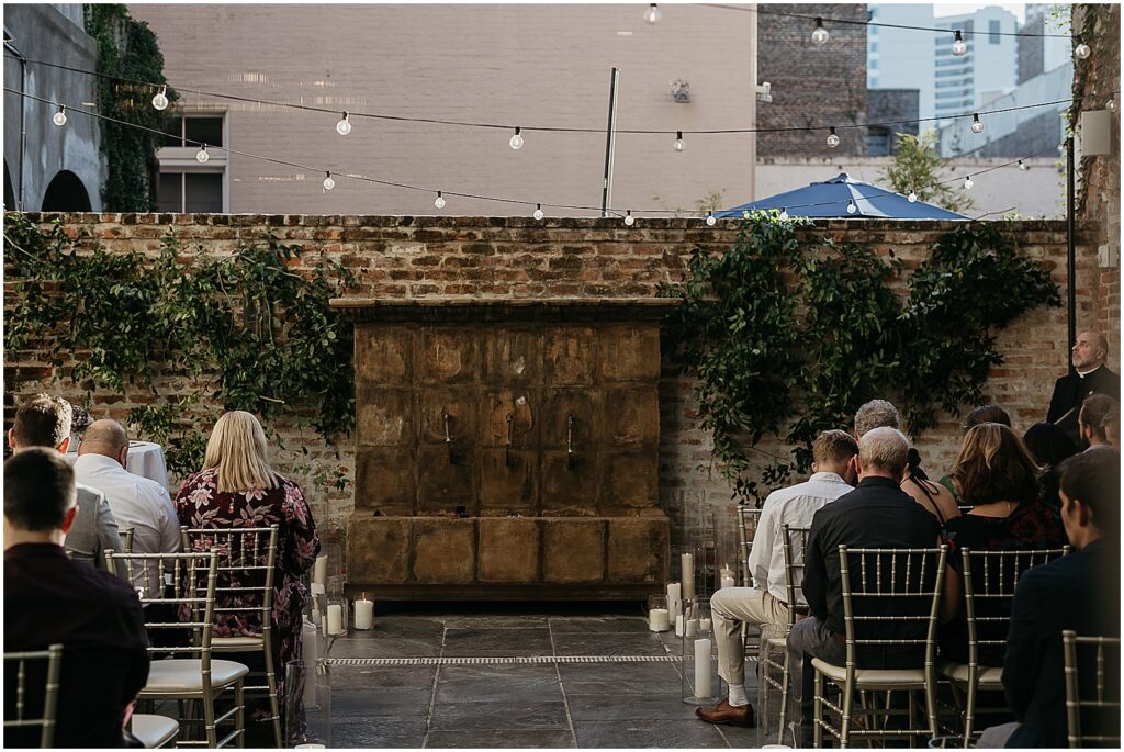 Wedding guests sit for a ceremony at a rooftop wedding venue in New orleans.