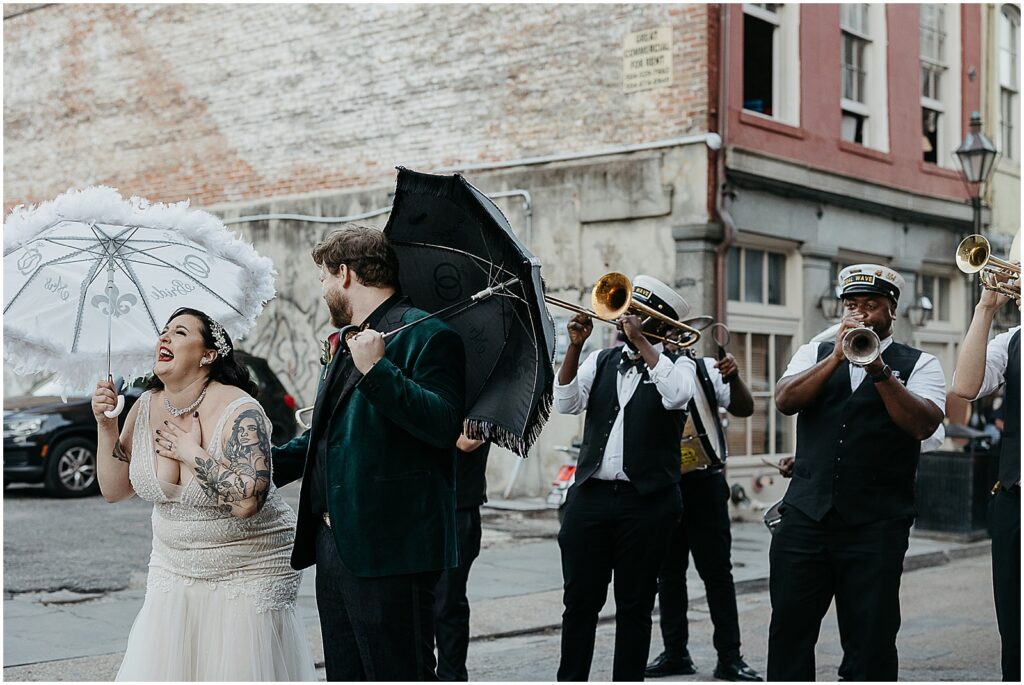 A brass band plays behind a bride and groom.