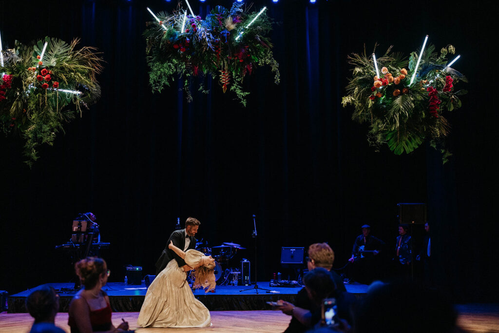 A groom dipping a bride at their reception 