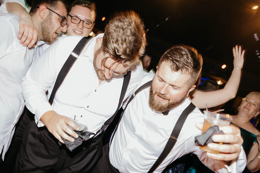 Wedding guests dancing together 
