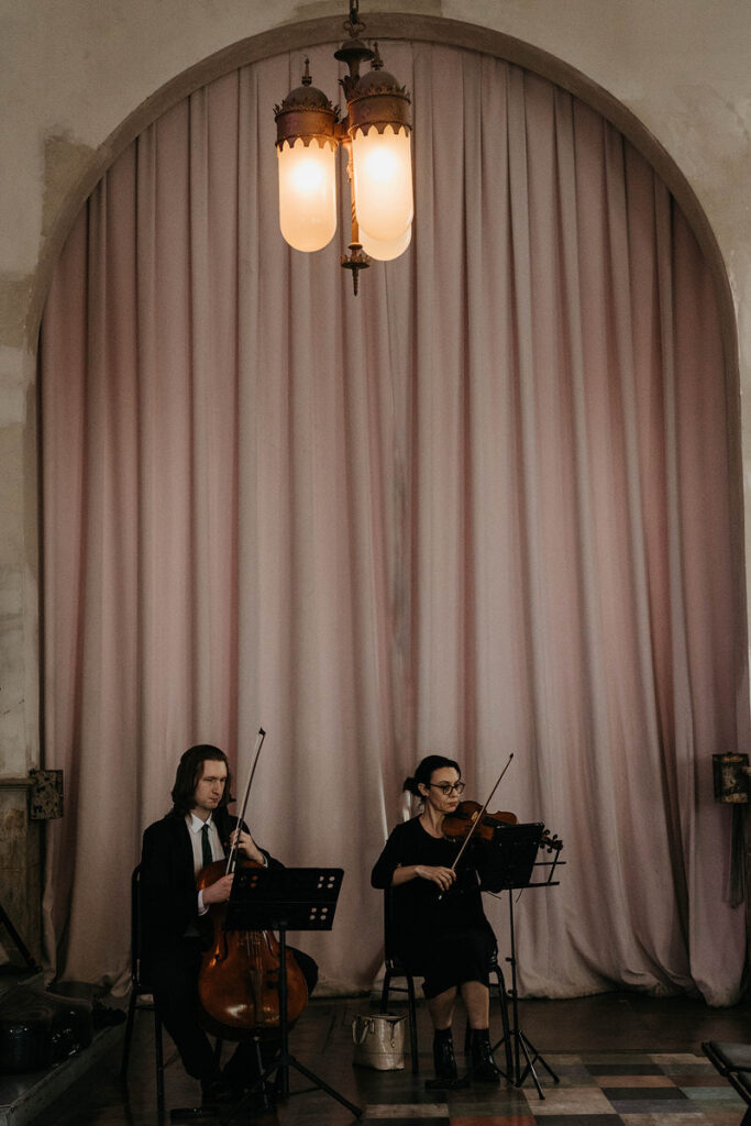 Two people playing the strings 