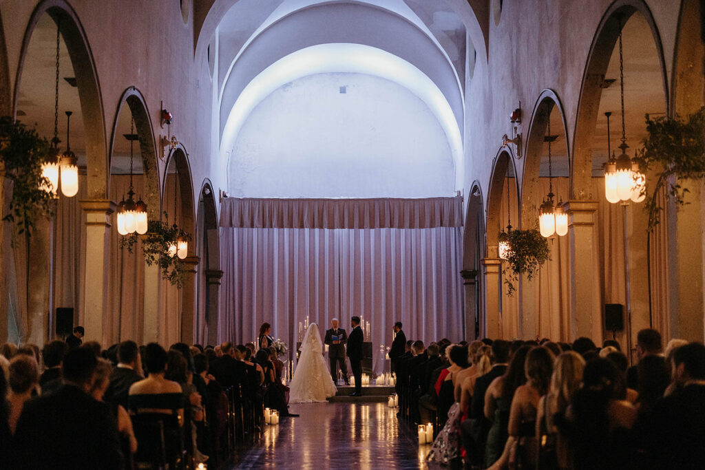 A couple from the end of the altar during their wedding 