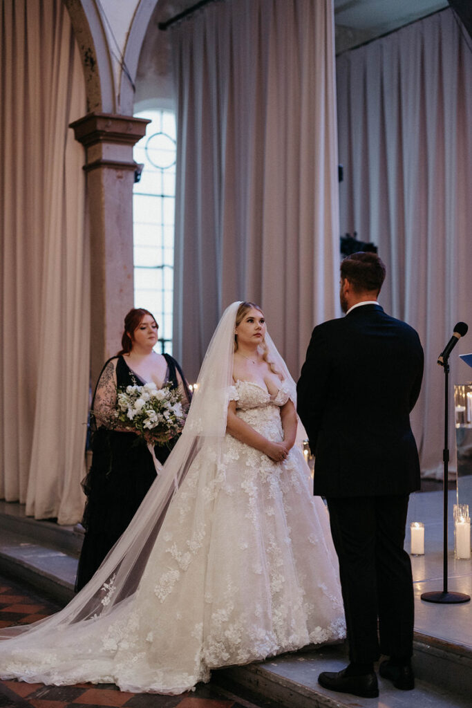 A couple standing up at the altar together during their wedding 
