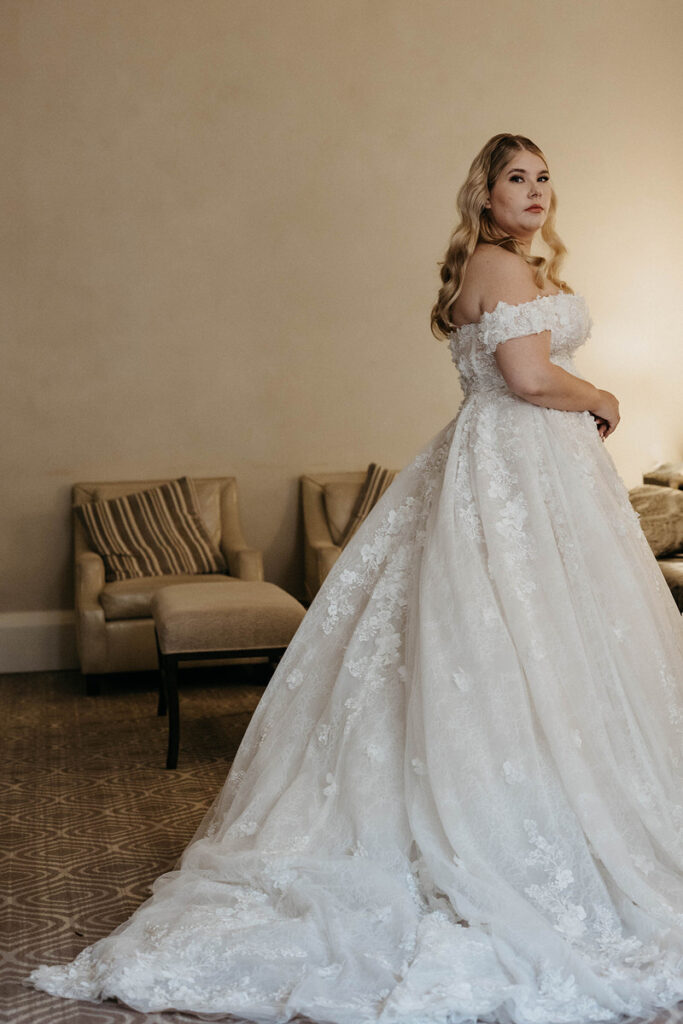 A person in a wedding dress looking over their shoulder 
