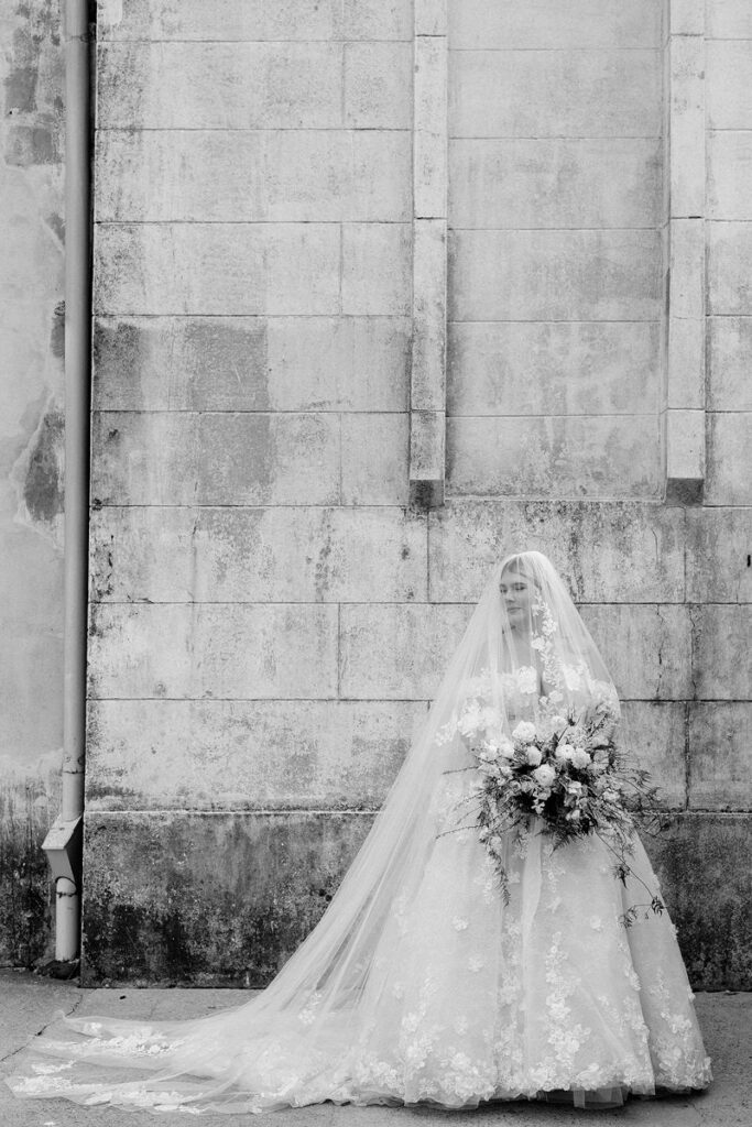 Black and white  photo of a bride holding a bouquet 
