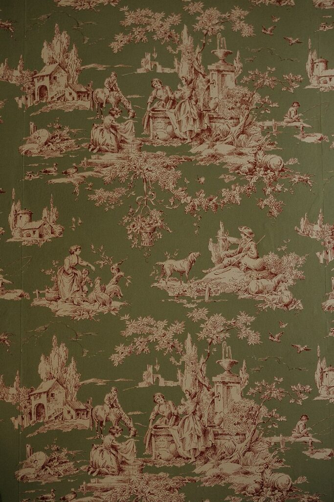 Green wallpaper featuring detailed pastoral scenes in a toile de Jouy pattern.