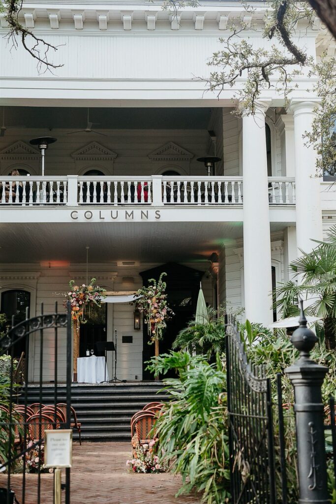 The Columns venue set up for the wedding ceremony, with a decorated chuppah and seating arranged outside.
