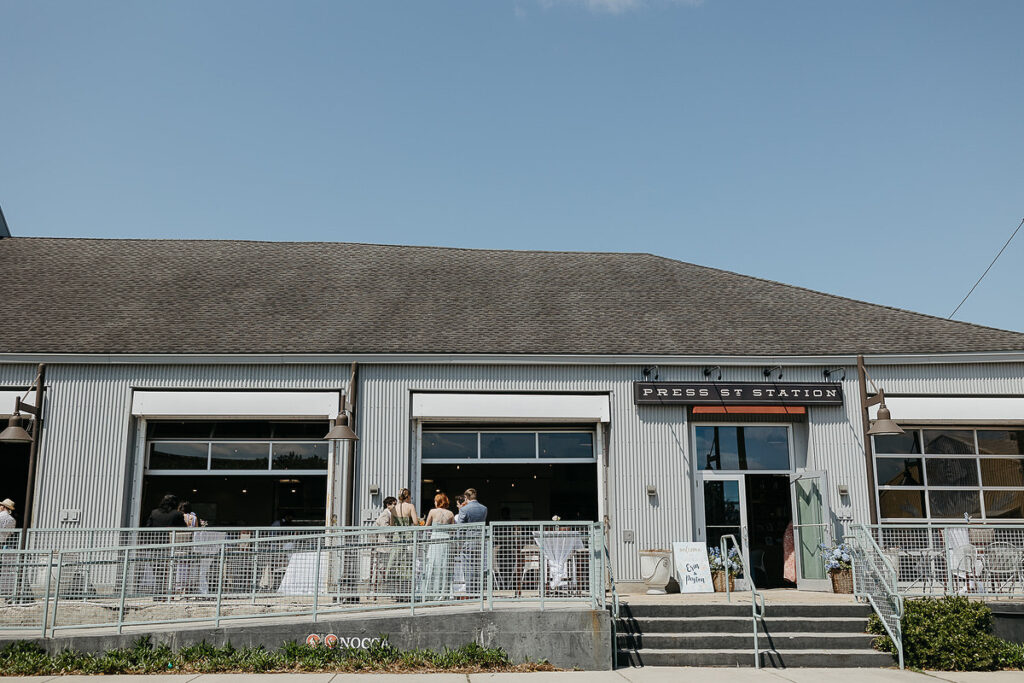 Exterior view of Press St Station, a modern event venue with large windows and metal siding