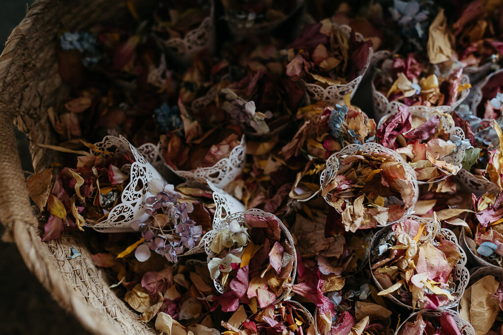 Close-up of a basket filled with colorful, dried flower petals, prepared for guests to toss during a celebratory moment