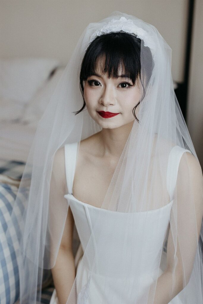 A person in a wedding dress and red lipstick 
