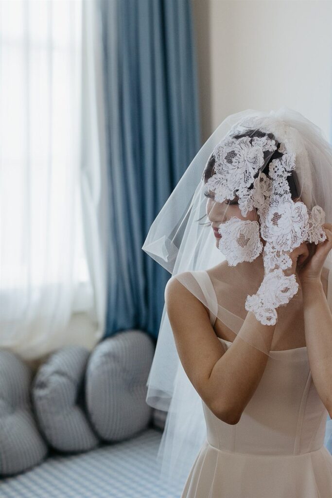 A bride putting on her earring 