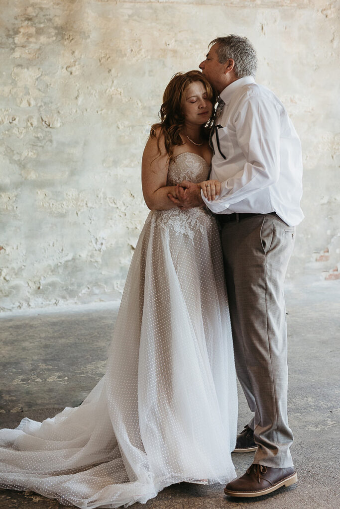 A bride hugging their father 