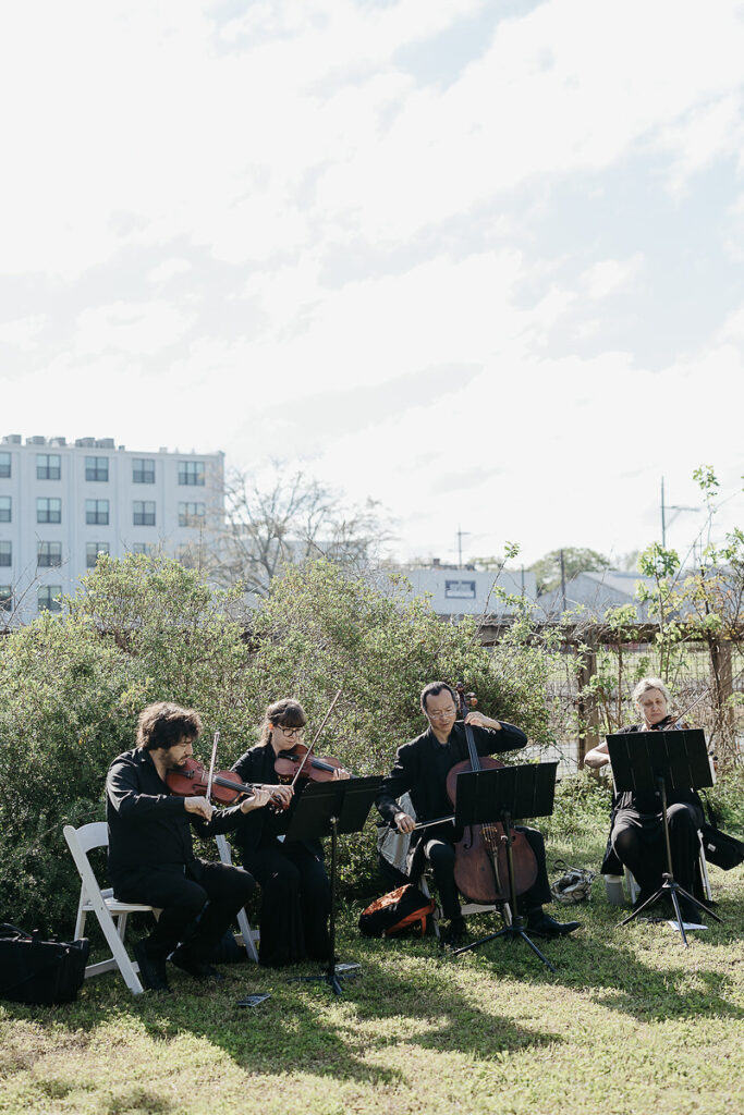 A string quartet playing outside 