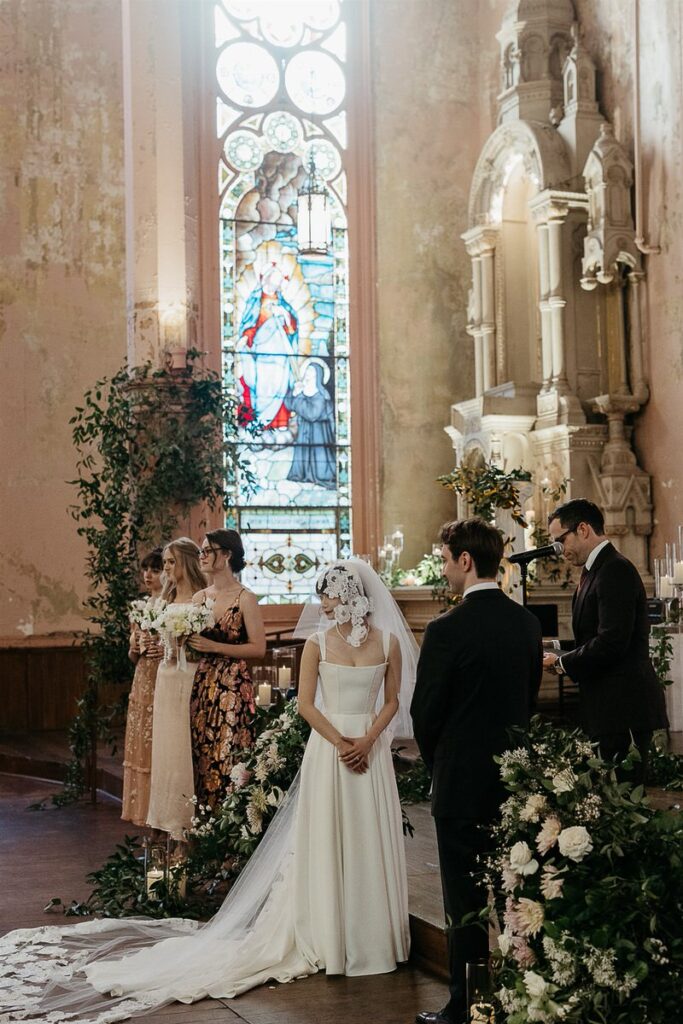 A bride and groom standing up at the wedding ceremony 