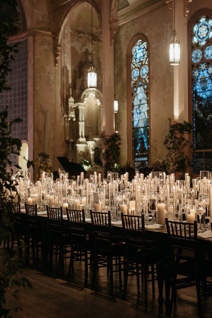 A long reception table covered in candles 