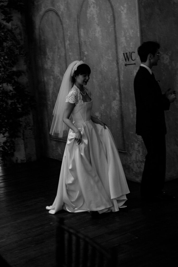 A bride and groom walking around an old building 