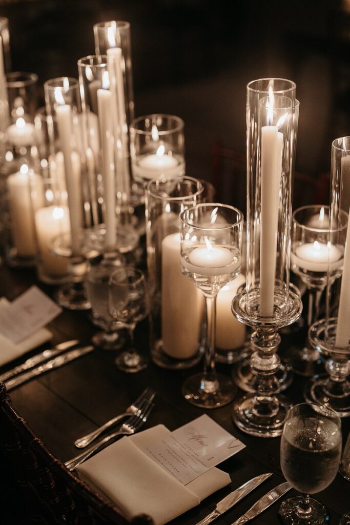 Candles set up in front of table settings