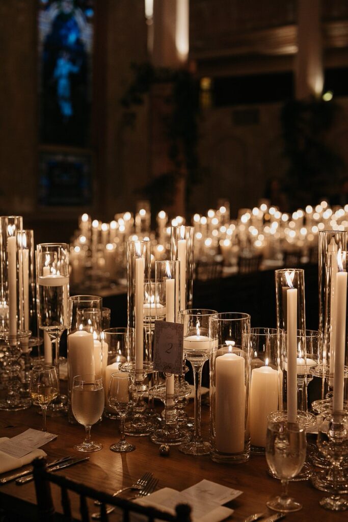 Various sized candles laid out on a reception table 