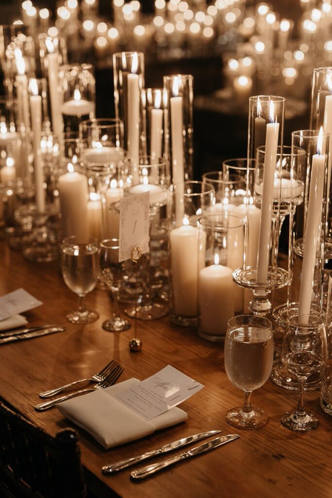 Table settings with candles along the edge of the table 