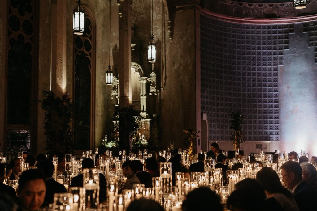 Guests sitting at wedding reception tables 