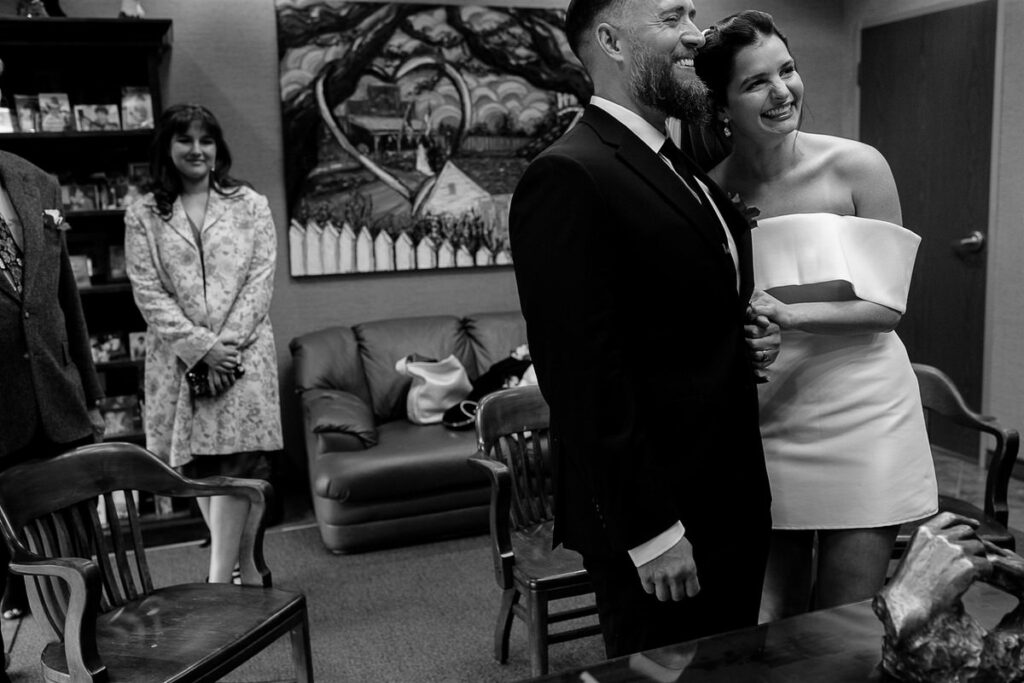 A couple standing in a courthouse getting married 
