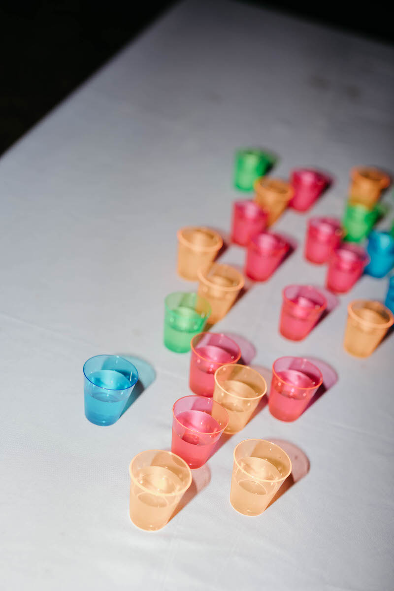 Colorful plastic shot glasses laid out in a table 