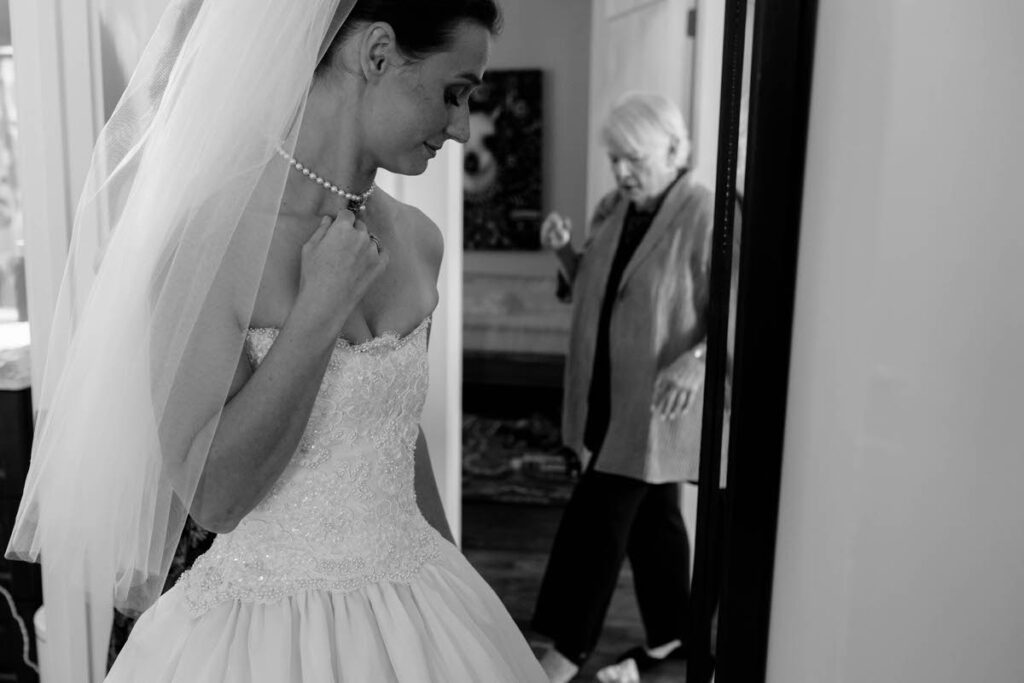Black and white photo of a person in a wedding dress looking down