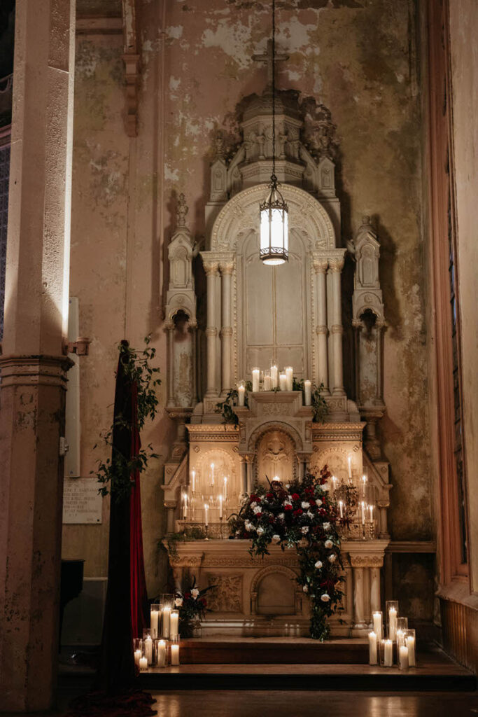 A small altar with candles and flowers decorating it