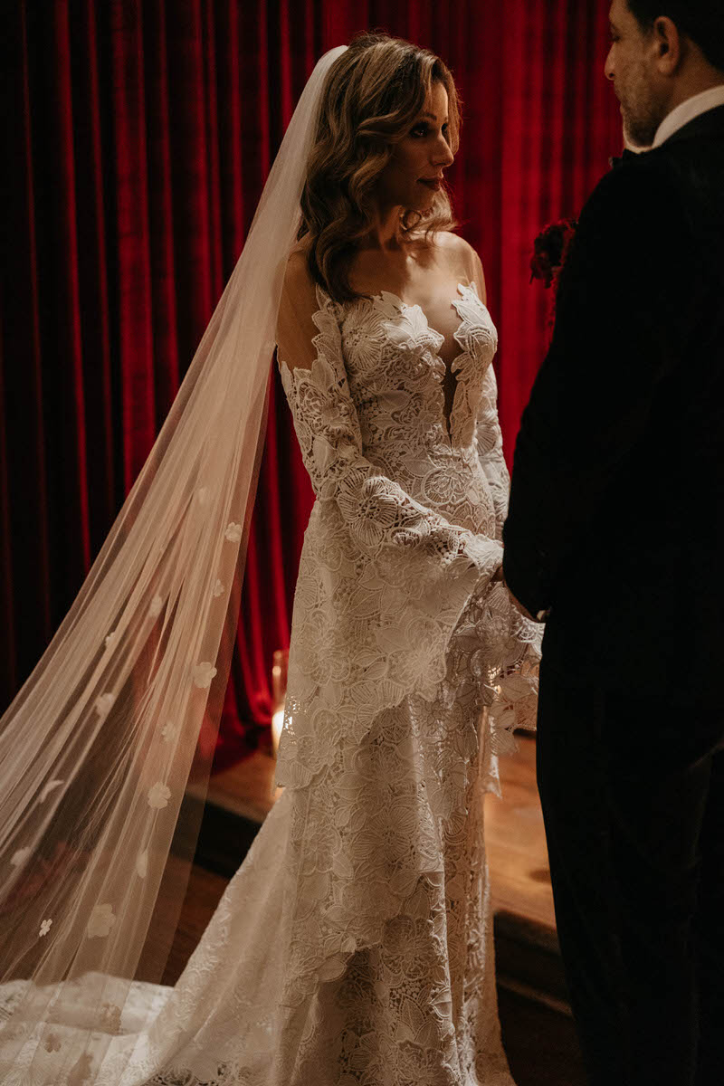 A couple holding hands as they say their vows at their wedding