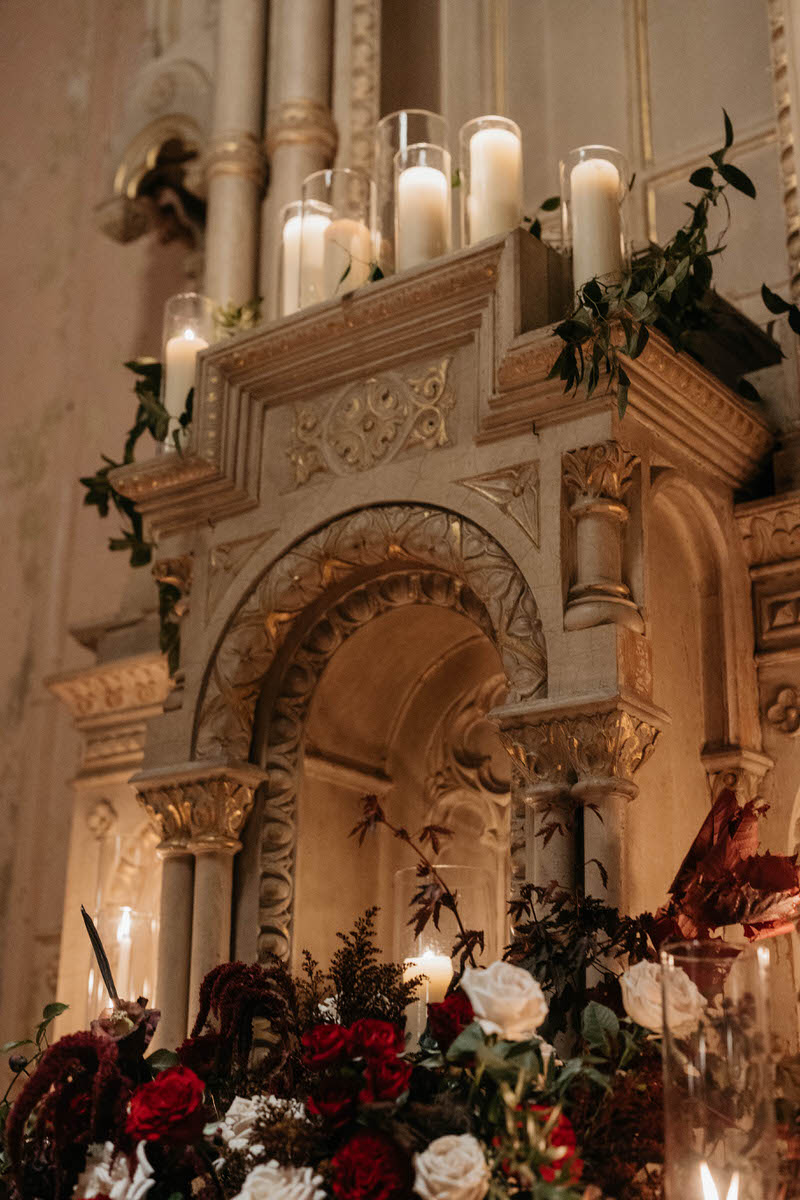 An ornate altar with candles and flowers around it