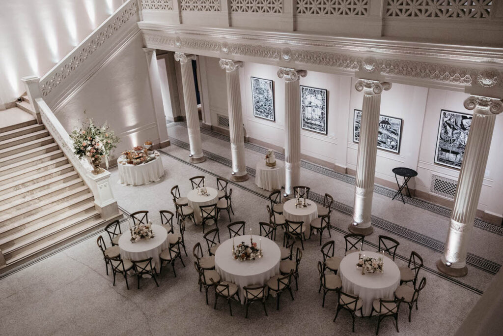 View looking down into a wedding reception area with circular tables set up