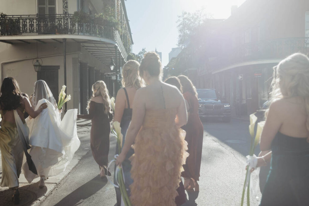A wedding party walking on the street on the way to a wedding