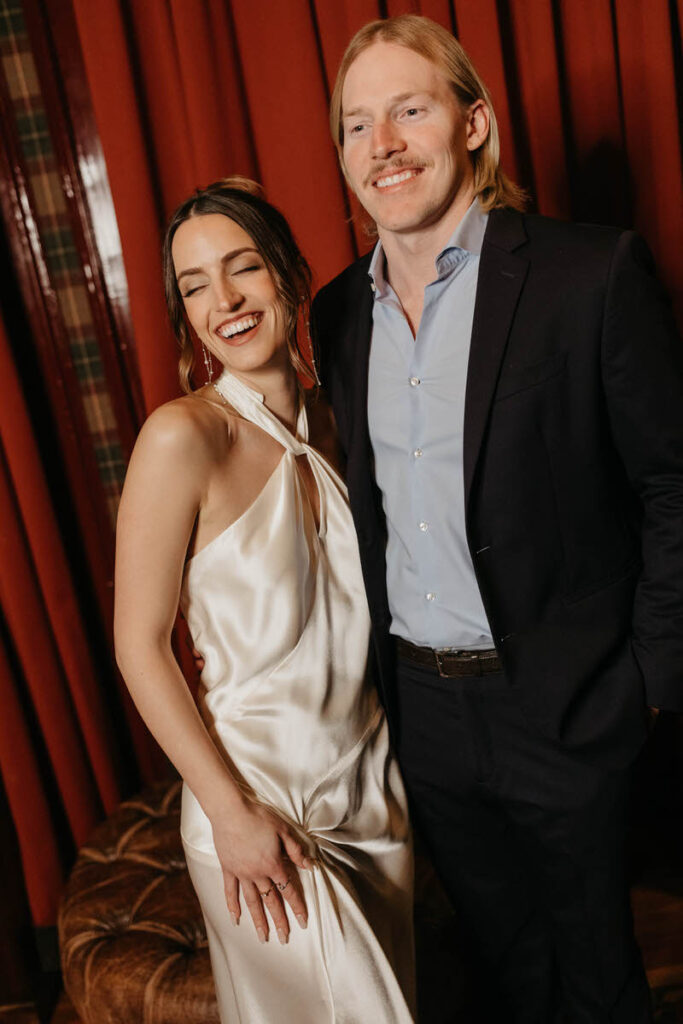 A couple with their arms around each other laughing