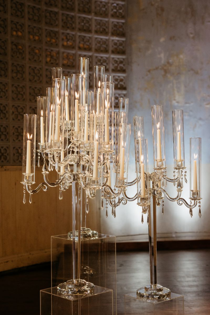 clearn candle holders fillled wit white candles in a church 