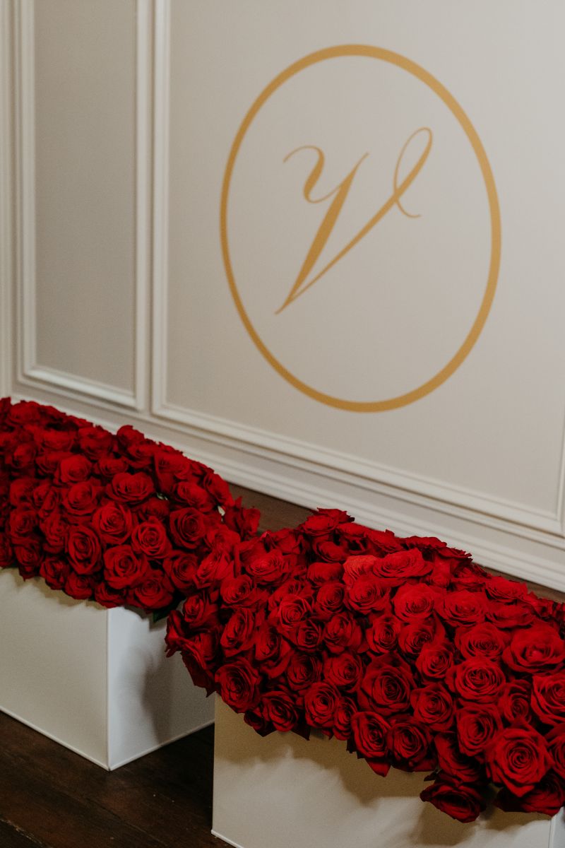 the front of a dj booth for a wedding decorated with red roses 