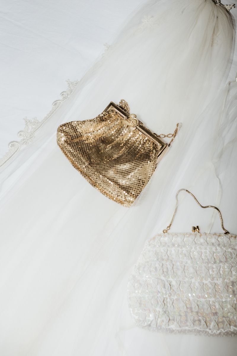 two clutch purses one is gold the other is white