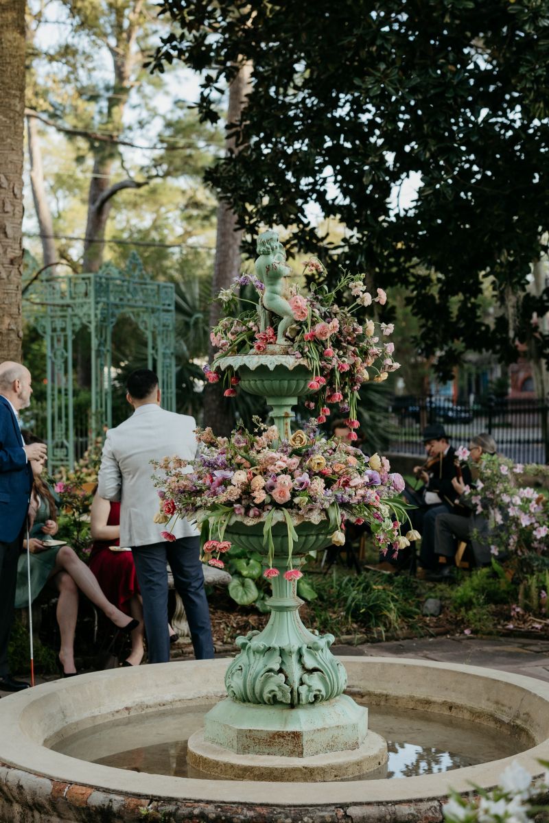 a fountain at derbes mansion in new orleans ornately decorated with flowers