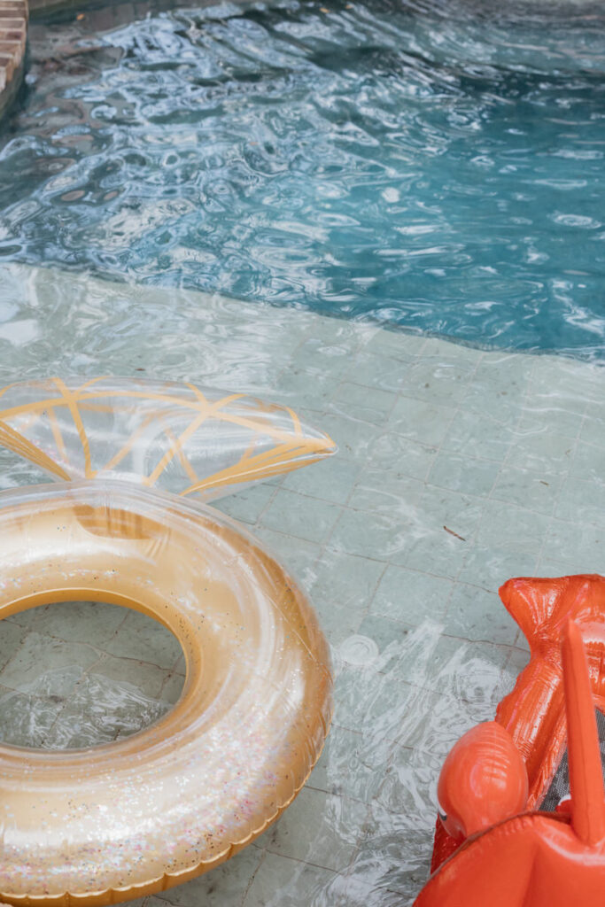 A ring and a crawfish floatie in a pool 