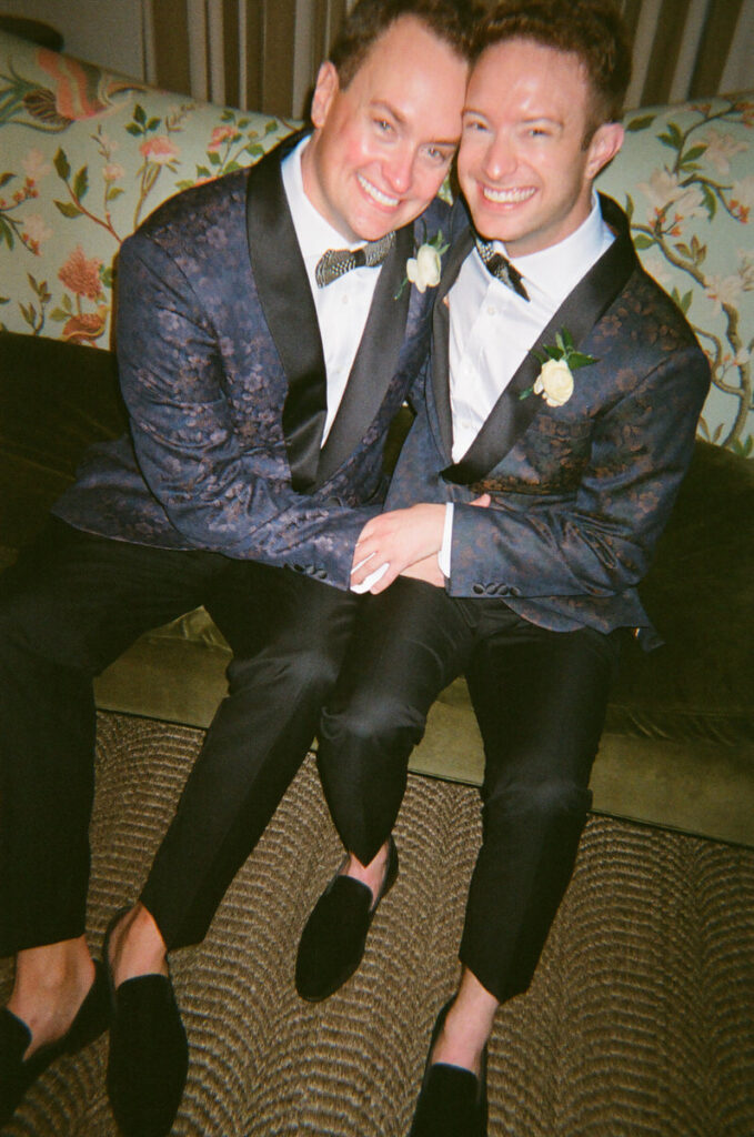 Newlywed sitting on a couch smiling together 