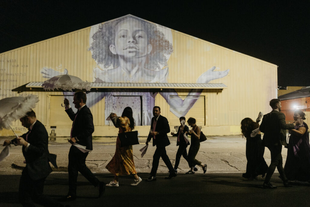 Wedding guests walking together in a Second Line in New Orleans 