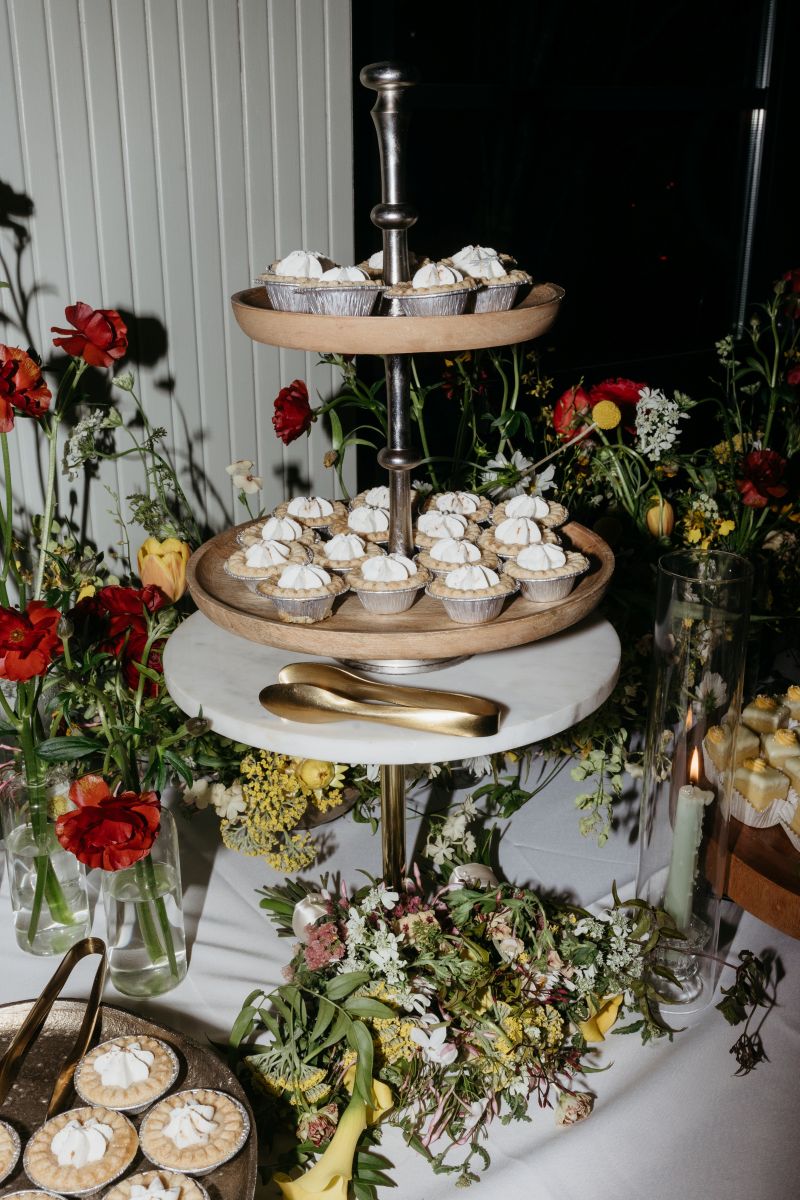 a colorful display of desserts and flowers at a wedding reception