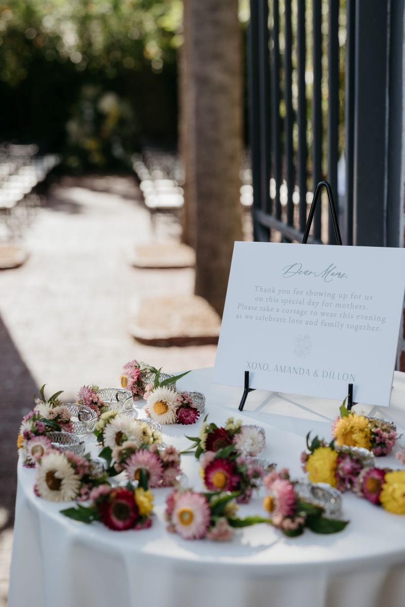 corsages resting on a table covered in a white table cloth