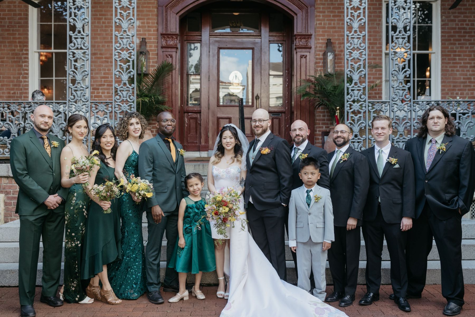a couple with their wedding party in front of hotel saint vincent on the day of their wedding