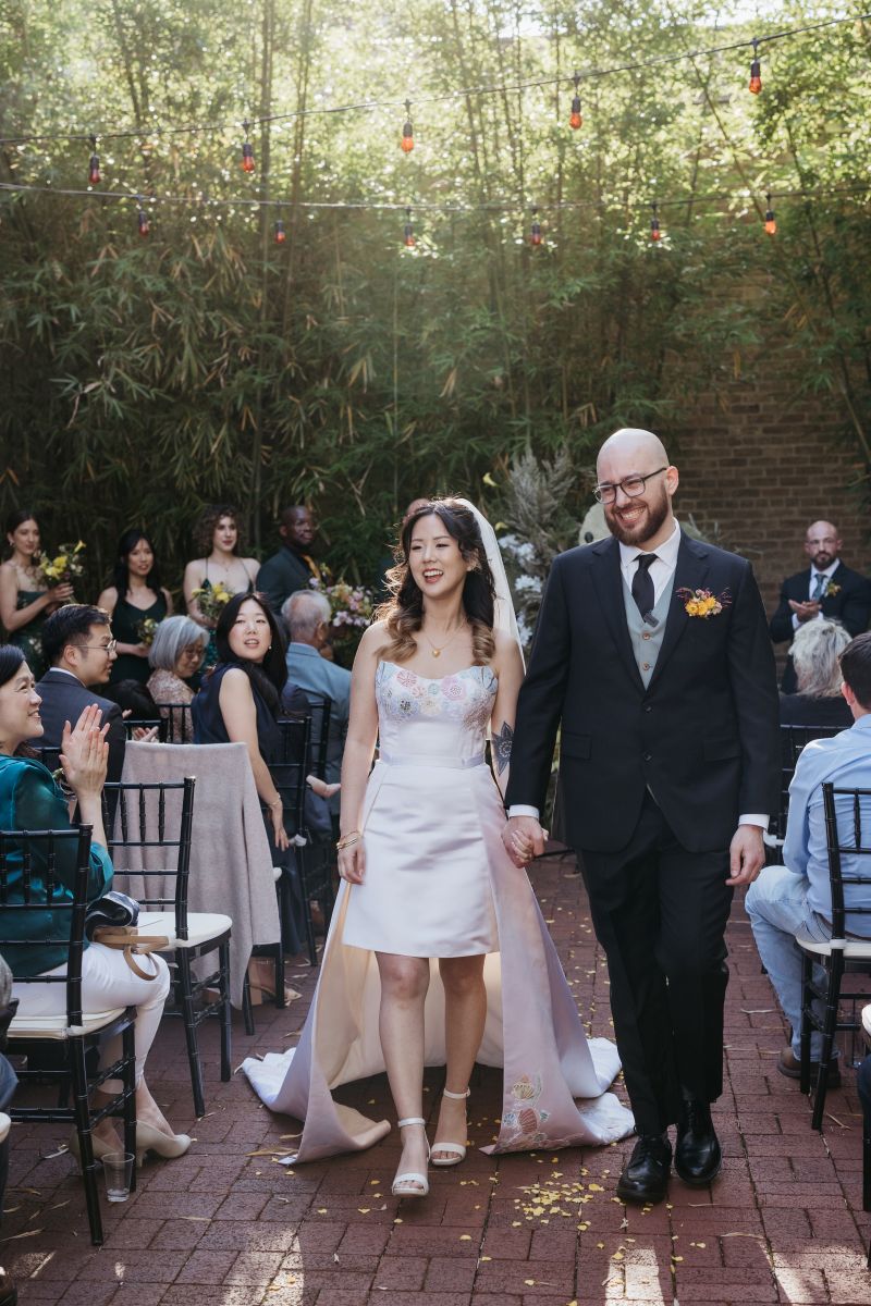 a couple smiling and holding hands after their wedding ceremony at hotel saint vincent